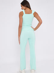 Ruches riemen slinky top- en breedbeen broekcoördin